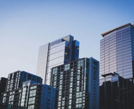 white and blue glass walled high rise building